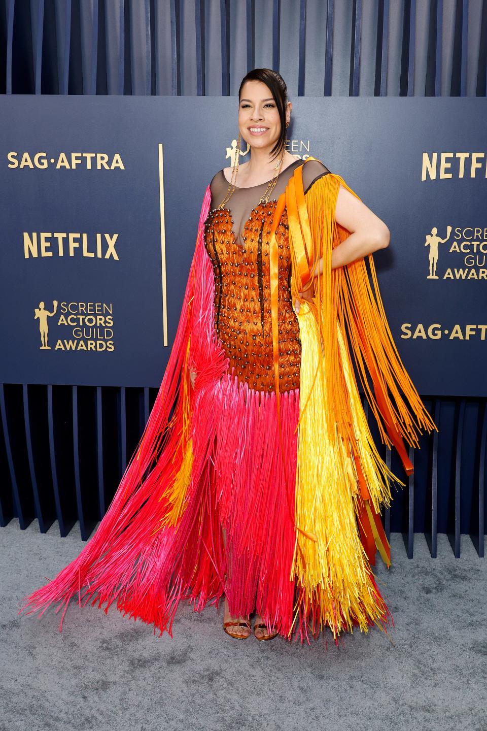 Cara Jade Myers in a pink and orange fringe dress