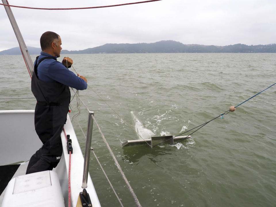 In this August 2017 photo, Dr. Marcus Eriksen from the nonprofit environmental group 5 Gyres, conducts research into microplastic pollution in the San Francisco Bay. The San Francisco Estuary Institute found microplastics in stormwater runoff entering the Pacific Ocean in a three-year study completed in 2019. (Shira Bezalel/San Francisco Estuary Institute via AP)