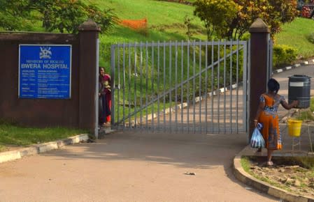 A woman walks to the Bwera general hospital near the border with the Democratic Republic of Congo in Bwera