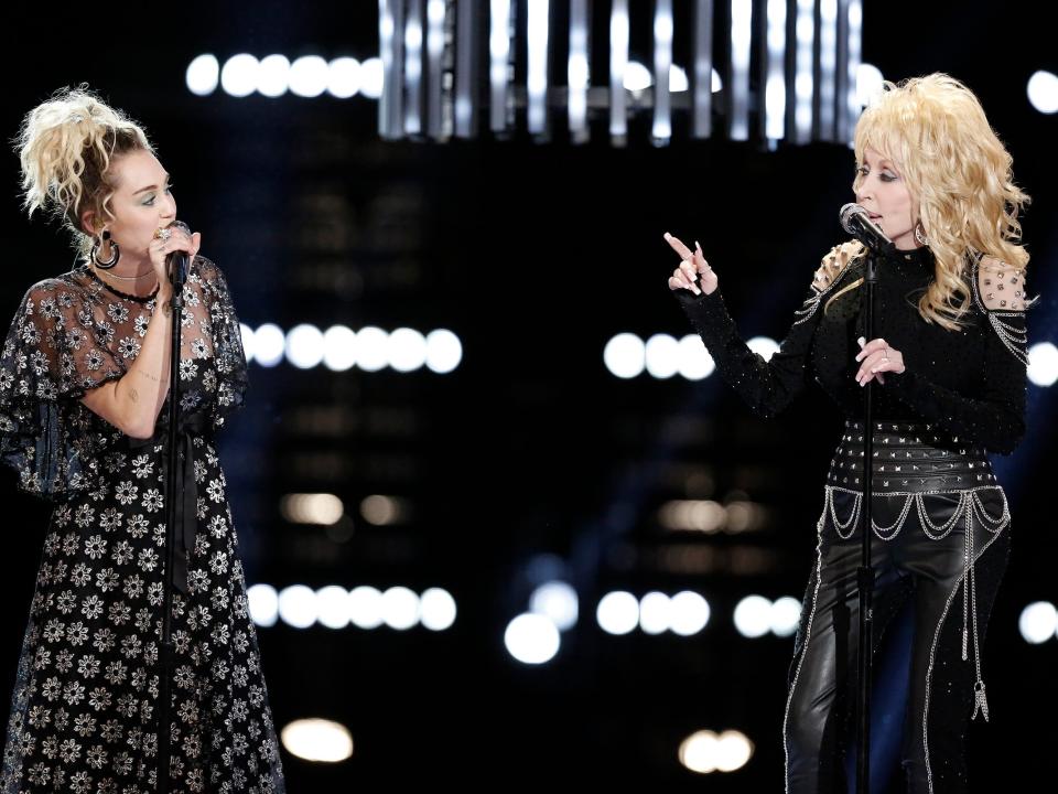Miley Cyrus and Dolly Parton performing on "The Voice" season 11.