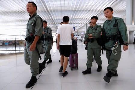 Riot police patrol inside Hong Kong International Airport in Hong Kong, China