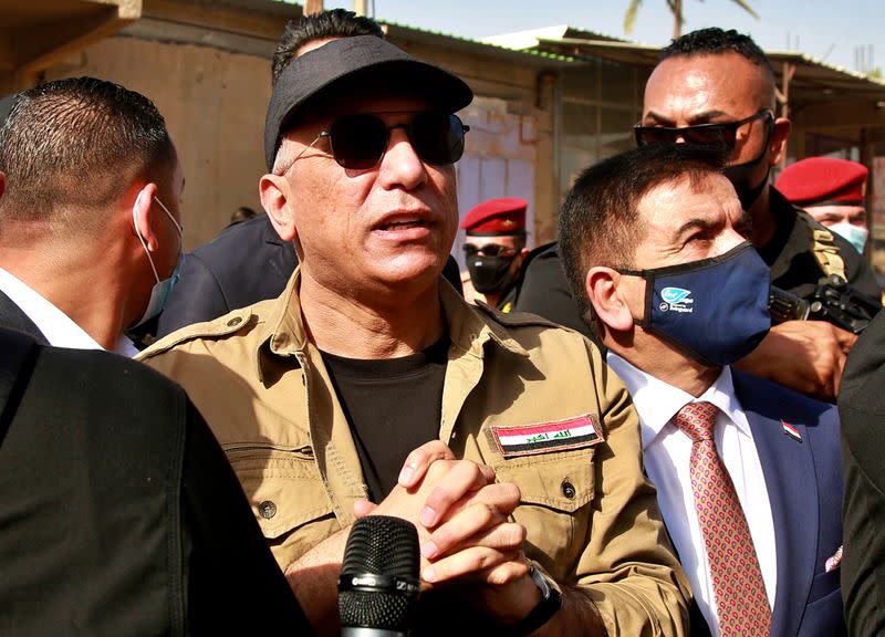 FILE PHOTO: Iraqi Prime Minister Mustafa al-Kadhimi speaks to locals in Tarmiyah