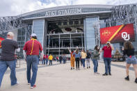 Fans enter AT&T Stadium before an NCAA college football game between Iowa State and Oklahoma for the Big 12 Conference championship, Saturday, Dec. 19, 2020, in Arlington, Texas. (AP Photo/Jeffrey McWhorter)