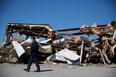 A man walks past a damaged airplane hangar at the Eufaula Municipal Airport, after a string of tornadoes, in Eufaula, Alabama, U.S., March 5, 2019. REUTERS/Elijah Nouvelage