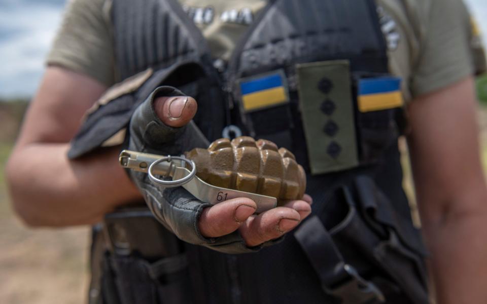 A volunteer holds his grenade - Julian Simmons for The Telegraph