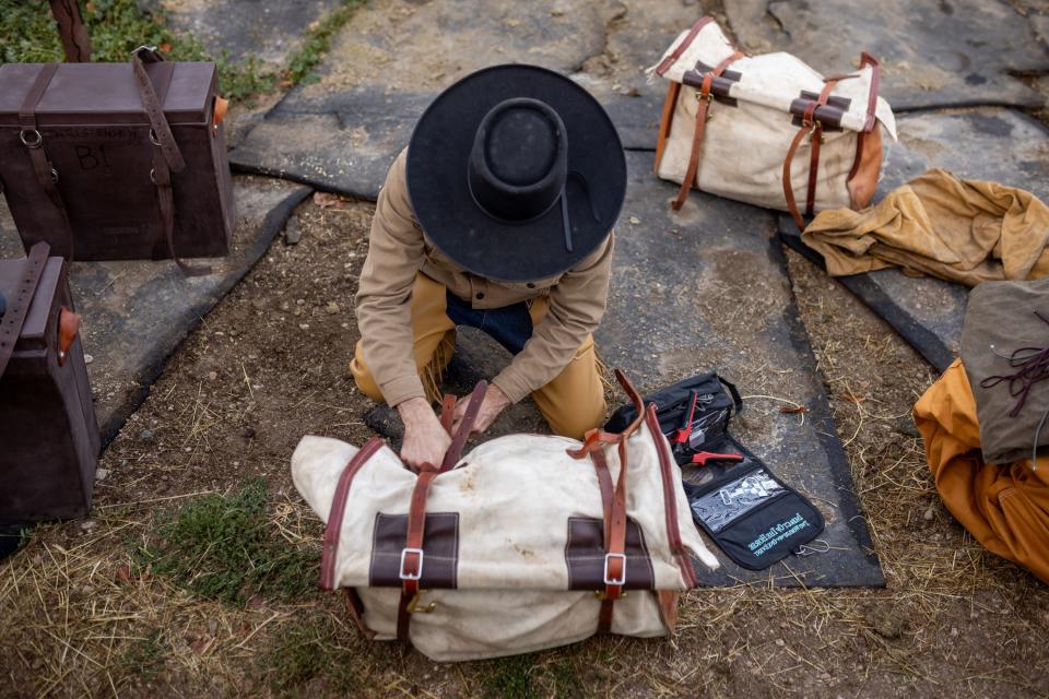Jake Harvath makes last-minute adjustments to a saddle bag as he prepares to begin his yearlong horse ride across the country at Sage Creek Equestrian in Charleston, Wasatch County, on Monday, Sept. 25, 2023. | Spenser Heaps, Deseret News
