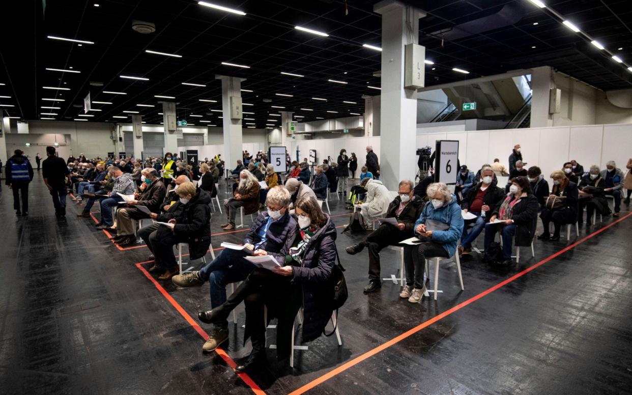 People wait for jabs at a vaccination centre in Cologne on Sunday April 4 -  Marius Becker/ DPA