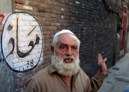 Barkat Ali, 66, speaks to Reuters correspondent near a school that Nobel Peace Prize laureate Malala Yousafzai used to attend, in her hometown of Mingora in Swat Valley, Pakistan March 30, 2018. REUTERS/Faisal Mahmood