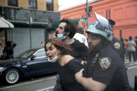FILE - In this May 30, 2020, file photo, New York Police officers restrain protesters during a demonstration in the Brooklyn borough of New York. Two civil rights organizations are suing the New York Police Department on behalf of protesters who say they were roughed up by officers because they expressed anti-police views during nightly demonstrations in the spring in the wake of George Floyd's killing. (AP Photo/Seth Wenig, File)