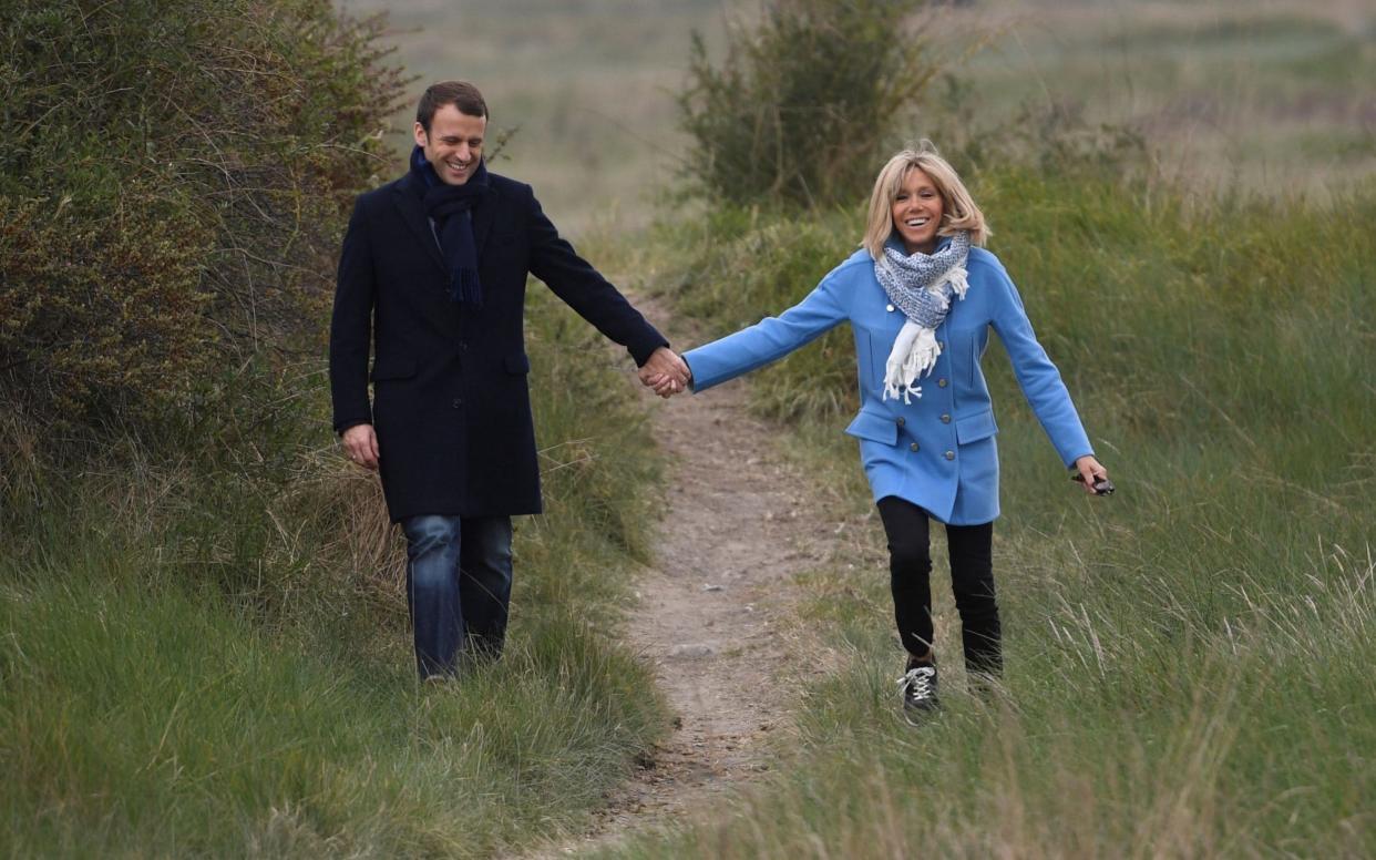 Emmanuel Macron with his wife Brigitte Trogneux - AFP