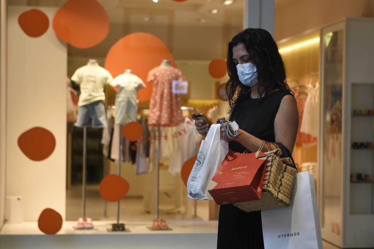 A costumer uses a face mask at the Norte Shopping Center in Porto, on June 1, 2020 as the shopping centres reopened after the lockdown to prevent the spread of coronavirus disease, COVID-19. - After a closure of two months and a half due to the coronavirus pandemic, cinemas, theatres and performance halls reopen as of today in Portugal, which continues its deconfinement process. Shopping centers may also reopen, except for those in the Lisbon region, where a more significant increase in Covid-19 cases occurred in recent days than in the rest of the country. (Photo by MIGUEL RIOPA / AFP) (Photo by MIGUEL RIOPA/AFP via Getty Images)