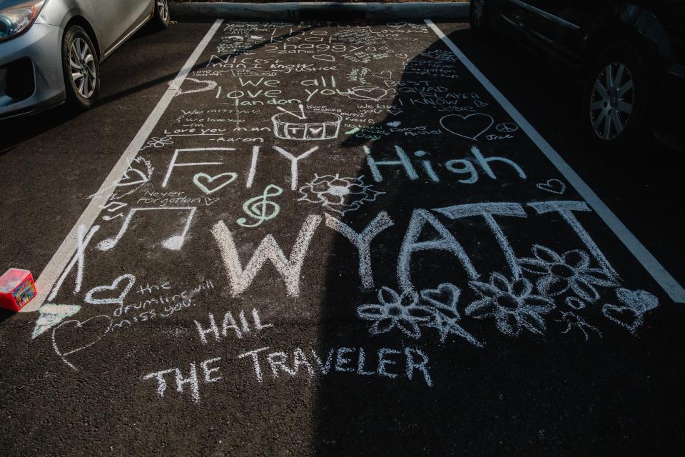 Chalk messages are seen left in remembrance of Wyatt Mosley, 18, a high school senior from Mineral City, Thursday, Nov. 16 at Tuscarawas Valley Middle-High School in Zoarville. Wyatt, along with 5 other people – 3 of whom were students, died in a bus crash in Licking County.