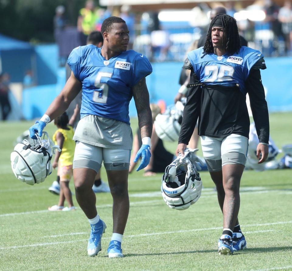 Lions running backs David Montgomery, left, and Jahmyr Gibbs walk off the field during training camp on Thursday, Aug. 3, 2023, in Allen Park.