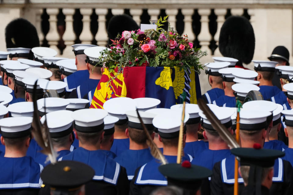 The State Gun Carriage carries the coffin of Queen Elizabeth II, draped in the Royal Standard with the Imperial State Crown and the Sovereign's orb and sceptre, in the Ceremonial Procession following her State Funeral at Westminster Abbey, London. Picture date: Monday September 19, 2022.