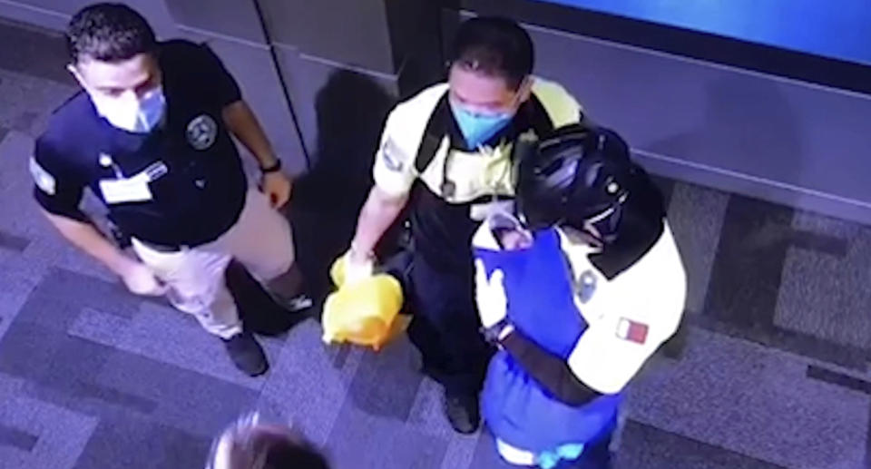 Qatar airport worked hold a baby found in a trash can in the bathroom 