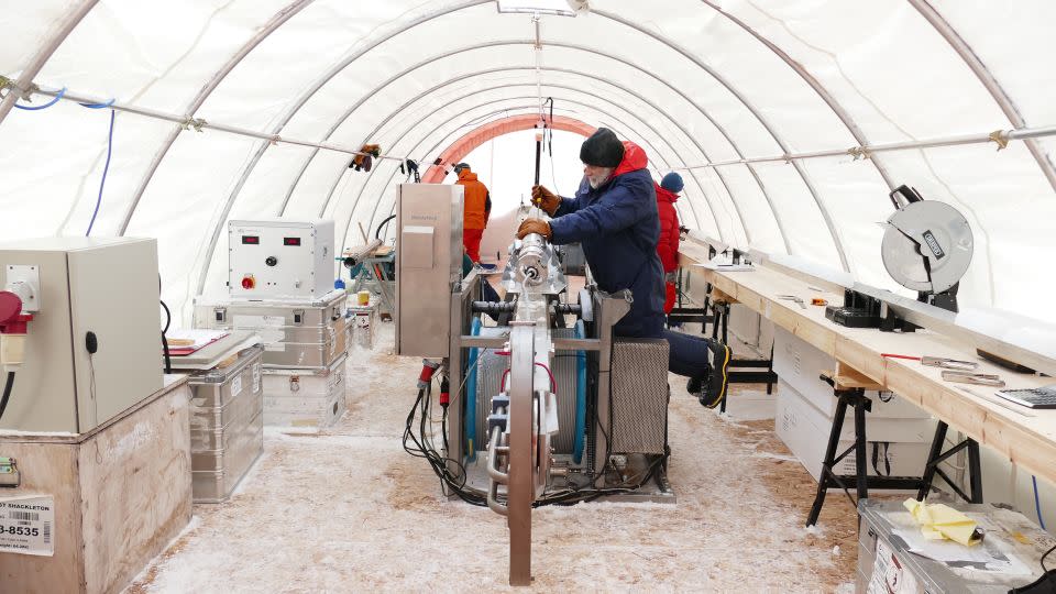 Inside the drilling tent at Skytrain Ice Rise, scientists preparing the drill for its next drop into the borehole. - University of Cambridge/British Antarctic Survey