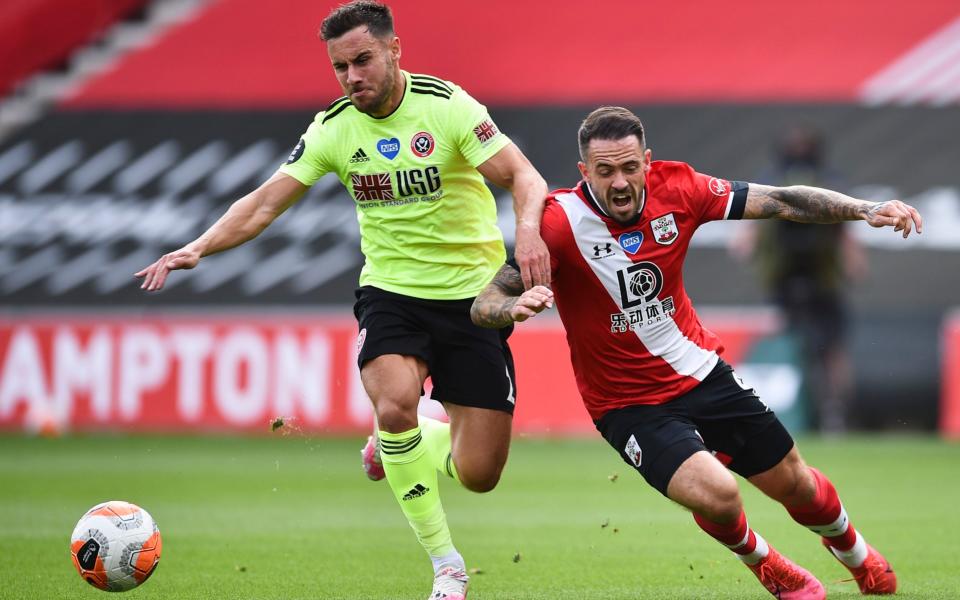 George Baldock in action against Southampton's Danny Ings - AFP