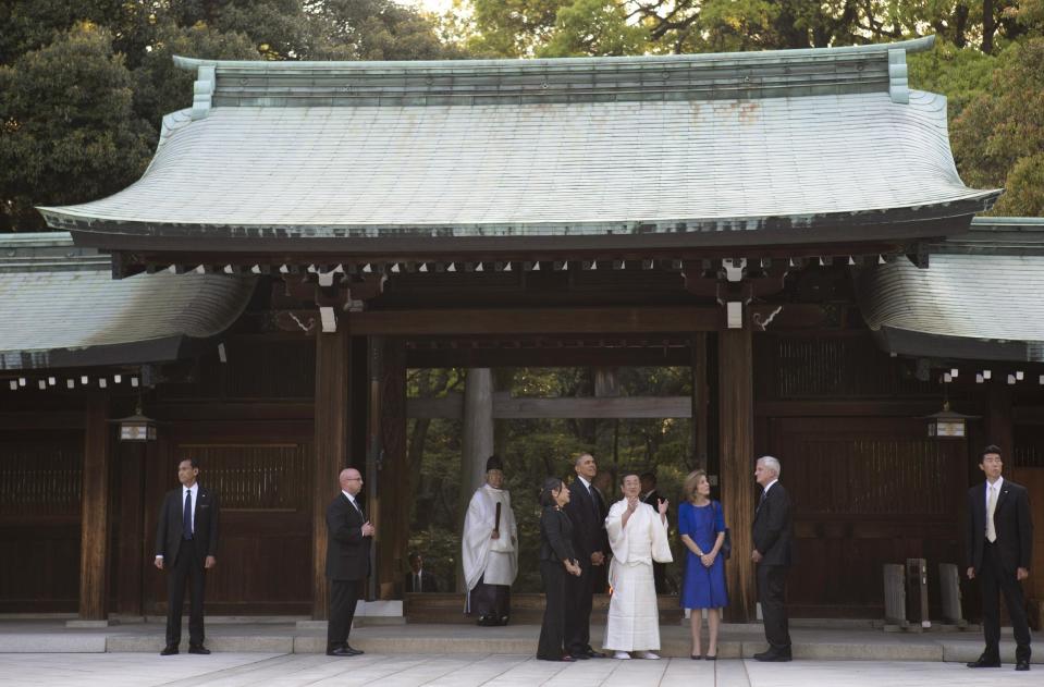 President Barack Obama tours Meiji Shrine in Tokyo, Thursday, April 24, 2014. Also on the tour with the president are chief priest Seitaro Nakajima, U.S. Ambassador to Japan Caroline Kennedy and her husband Edwin Schlossberg. Showing solidarity with Japan, Obama affirmed Thursday that the U.S. would be obligated to defend Tokyo in a confrontation with Beijing over a set of disputed islands, but urged all sides to resolve the long-running dispute peacefully. (AP Photo/Carolyn Kaster)