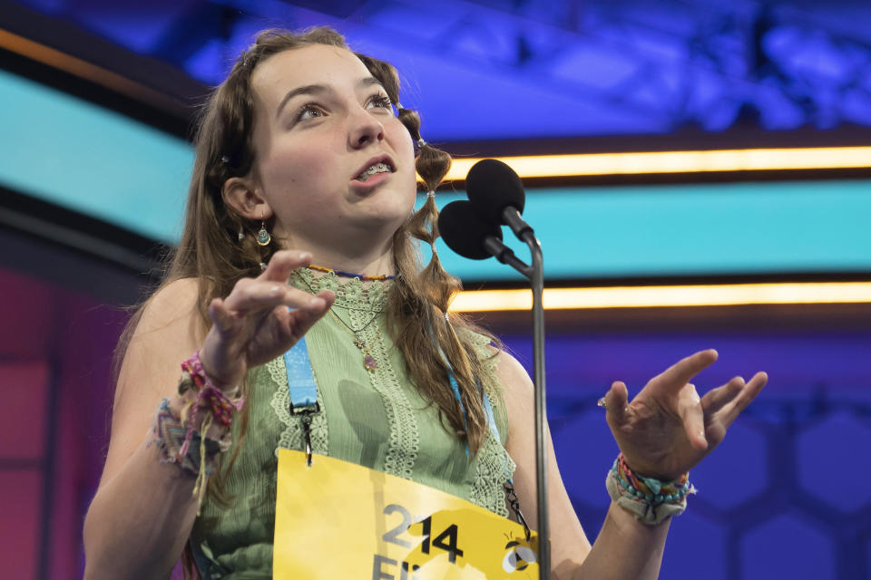 Elise Cournoyer, 14, from Richmond,Vt., mimes typing a word while competing during the Scripps National Spelling Bee, Wednesday, May 31, 2023, in Oxon Hill, Md. (AP Photo/Nathan Howard)