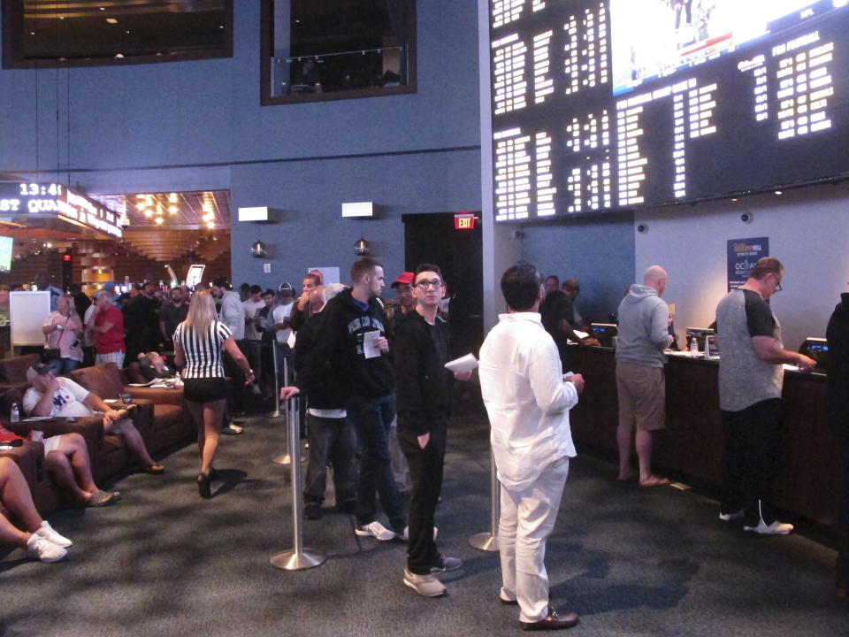 Gamblers line up to make sports bets at the Ocean Casino Resort in Atlantic City, N.J., on Sept. 9, 2018. NFL officials on Tuesday, Jan. 30, 2024, said viewers will only see three sports betting ads during the broadcast of the Super Bowl on Feb. 11. (AP Photo/Wayne Parry)