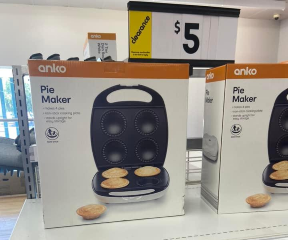 A photo of Kmart's $5 pie maker in a white box on the Kmart shelf with a clearance sign promoting it on sale for five dollars.