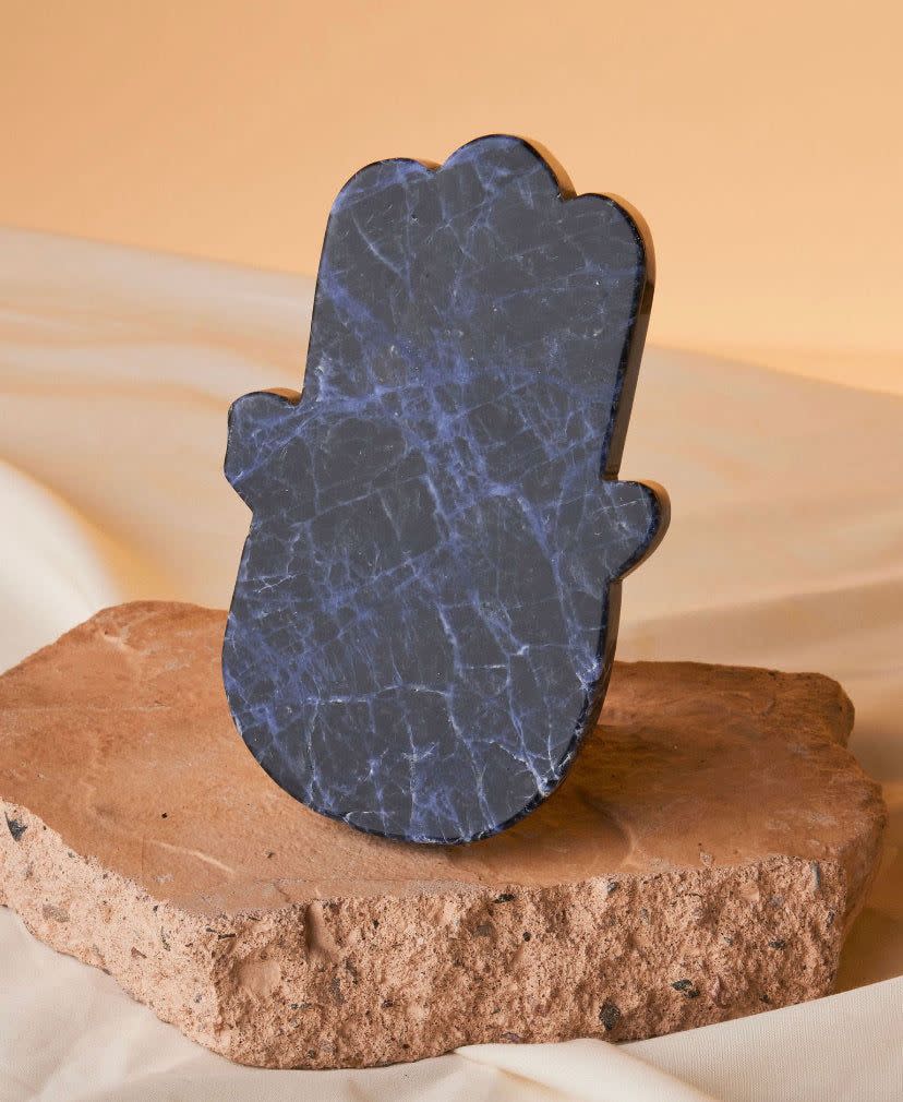 <p><a href="https://heritage-apothecary.com/products/sodalite-crystal-hamsa-hand" rel="nofollow noopener" target="_blank" data-ylk="slk:Shop Now;elm:context_link;itc:0;sec:content-canvas" class="link rapid-noclick-resp">Shop Now</a></p><p>Sodalite Crystal Hamsa Hand</p><p>heritage-apothecary.com</p><p>$74.00</p>