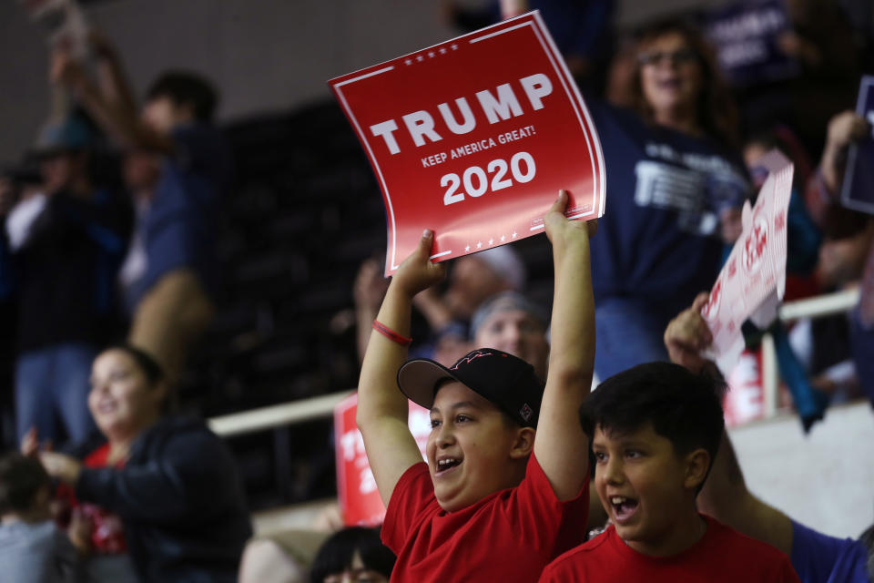 A supporter holds up a "Trump 2020" sign during a rally by U.S. President Donald Trump in Lake Charles, Louisiana, U.S., October 11, 2019. REUTERS/Leah Millis