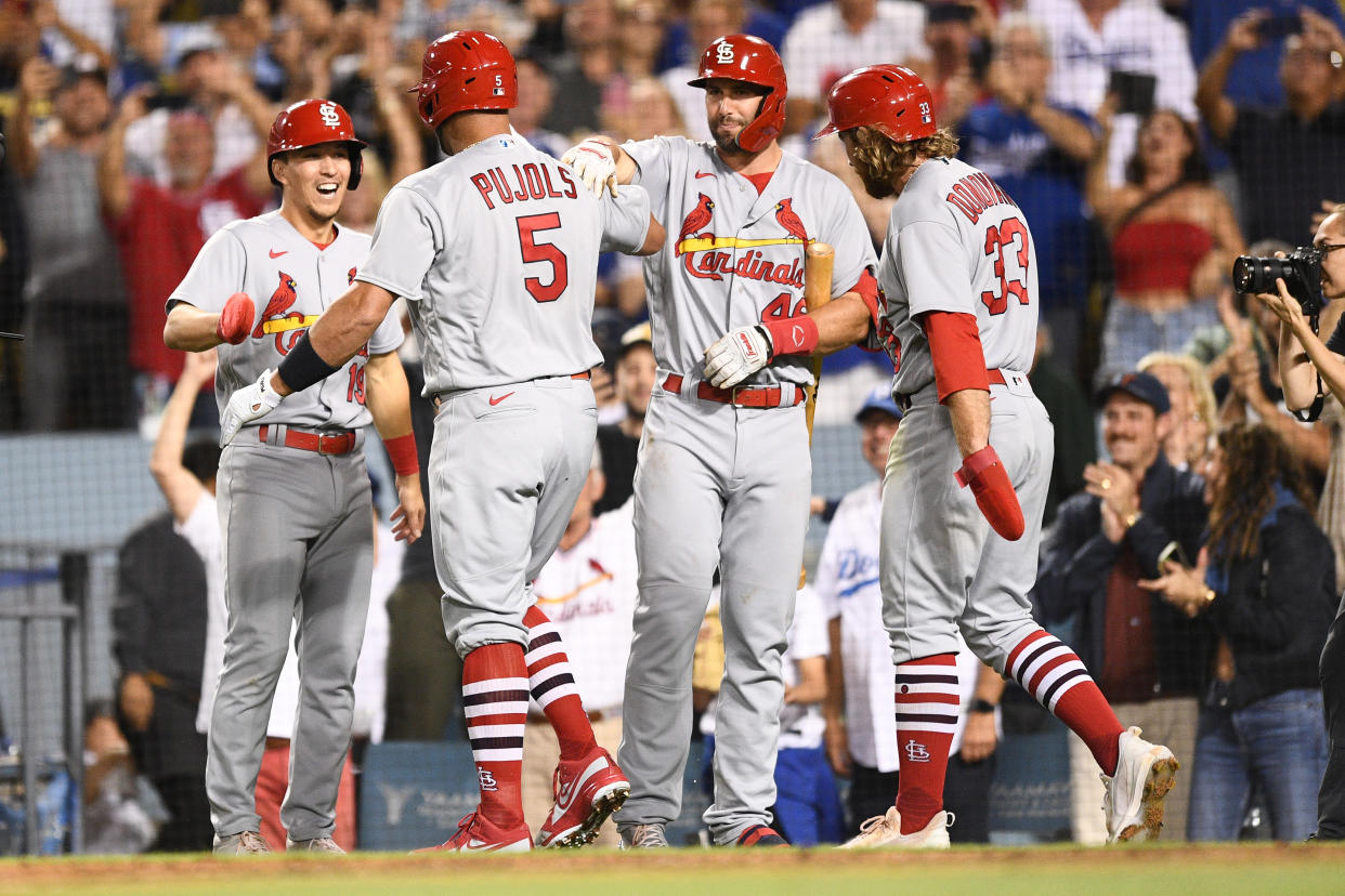 LOS ANGELES, CA - SEPTEMBER 23: MLB St. Louis Cardinals designated hitter Albert Pujols (5) is greeted by St. Louis Cardinals second baseman Brendan Donovan (33), St. Louis Cardinals first baseman Paul Goldschmidt (46)and St. Louis Cardinals shortstop Tommy Edman (19) after hitting career home run number 700 during the MLB game between the St. Louis Cardinals and the Los Angeles Dodgers on September 23, 2022 at Dodger Stadium in Los Angeles, CA. (Photo by Brian Rothmuller/Icon Sportswire via Getty Images)