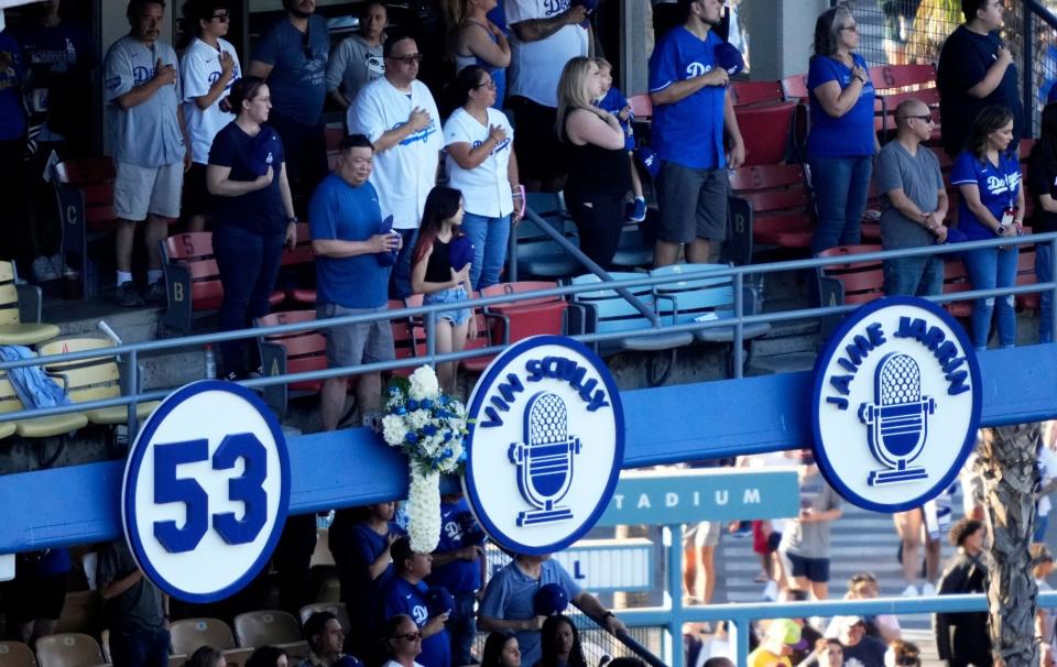 Los Angeles, CA - August 05: A bouquet hangs next to the retired Vic Scully mic as the Los Angeles Dodgers celebrate the life of Hall of Fame broadcaster Vin Scully who passed away Tuesday night at the age of 94 prior to a MLB baseball game between the Los Angeles Dodgers and the San Diego Padres at Dodger Stadium in Los Angeles on Friday, August 5, 2022. (Photo by Keith Birmingham/MediaNews Group/Pasadena Star-News via Getty Images)