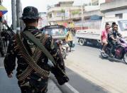 Philippine soldiers patrol the streets of Zamboanga, on the southern island of Mindanao, on September 21, 2013. Philippine President Benigno Aquino has flown out of the southern city where troops are fighting Muslim rebels, saying he expects the deadly battles to be over soon