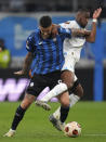 Atalanta's Gianluca Scamacca, left, challenges Marseille's Geoffrey Kondogbia during the Europa League semifinal first leg soccer match between Olympique de Marseille and Atalanta at the Velodrome stadium in Marseille, France, Thursday, May 2, 2024. (AP Photo/Daniel Cole)