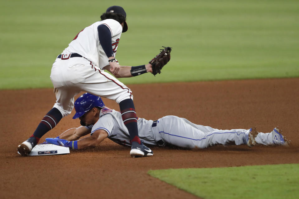 New York Mets' Andres Gimenez (60) steals second base as Atlanta Braves shortstop Dansby Swanson (7) allies the late tag in the seventh inning of a baseball game Monday, Aug. 3, 2020, in Atlanta. (AP Photo/John Bazemore)