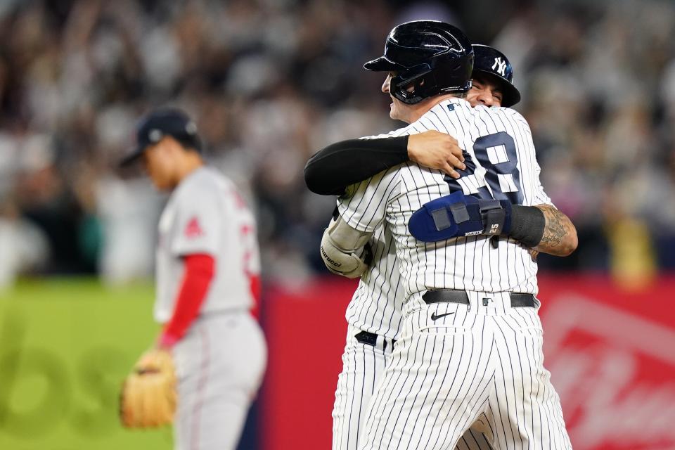 New York Yankees' Josh Donaldson (28) celebrates with Gleyber Torres as a Boston Red Sox player leaves the field after Donaldson hit a walk-off RBI single during the 10th inning of a baseball game Thursday, Sept. 22, 2022, in New York. The Yankees won 5-4. (AP Photo/Frank Franklin II)