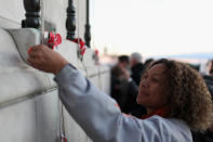 People place poppies on the Cenotaph at the Auckland War Memorial Museum during the ANZAC Day Dawn Service on April 25, 2012 in Auckland, New Zealand. Veterans, dignitaries and members of the public today marked ANZAC (Australia New Zealand Army Corps) Day, when First World War troops landed on the Gallipoli Peninsula, Turkey early April 25, 1915, commemorating the event with ceremonies of remembrance for those who fought and died in all wars. (Photo by Phil Walter/Getty Images)