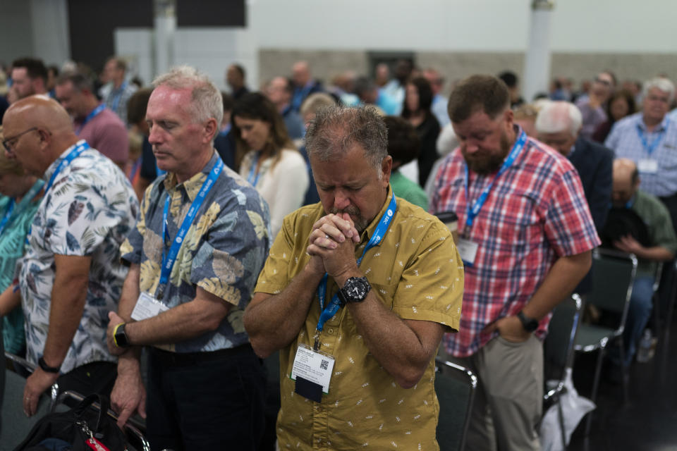 Attendees pray during the Southern Baptist Convention's annual meeting in Anaheim, Calif., Tuesday, June 14, 2022. (AP Photo/Jae C. Hong)