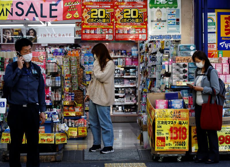 FILE PHOTO: A woman chooses products at a drug store in Tokyo