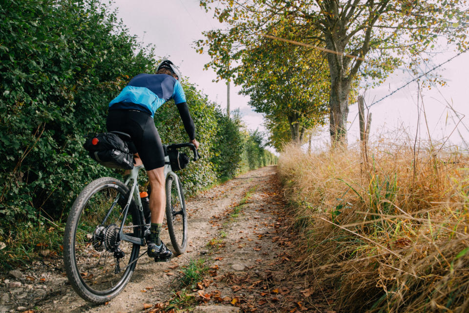 Male cyclist riding on gravel