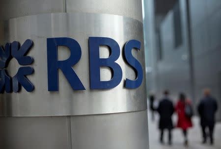 People walk past a Royal Bank of Scotland office in London, Britain, February 6, 2013. REUTERS/Neil Hall/File Photo