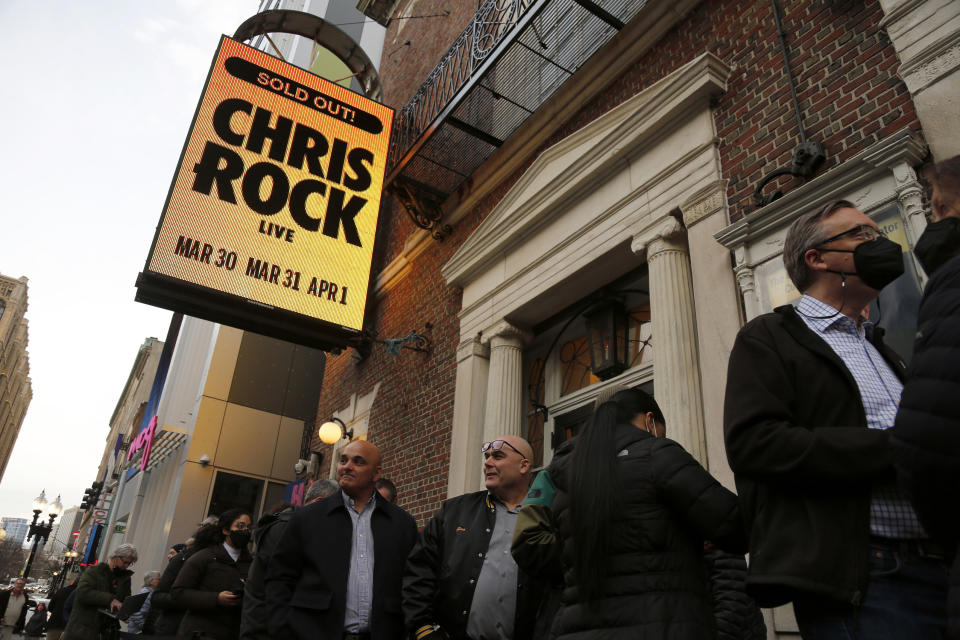 Ticket holders wait to enter the Wilbur Theatre for a performance by Chris Rock, Wednesday, March 30, 2022, in Boston. (AP Photo/Mary Schwalm)