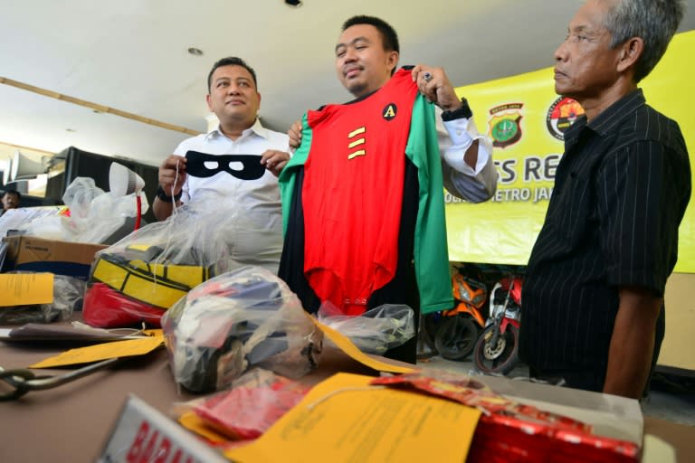 Indonesian police show evidence from the recent raid during a press conference at a police station in Jakarta