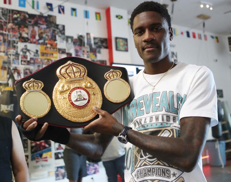 Dominique Crowder holds up his championship belt during a ceremony at APJ Boxing in Poughkeepsie Aug. 23, 2023. Crowder, a former Poughkeepsie resident, won the WBA bantamweight international title earlier this month and he was celebrated in a ceremony by the gym that first trained him.