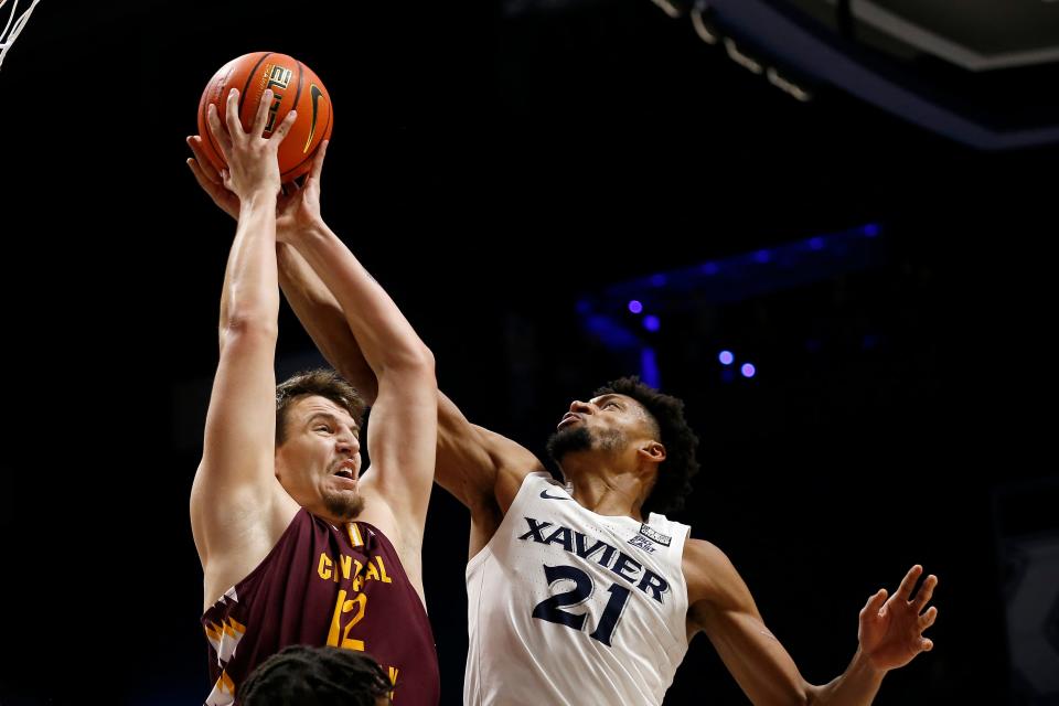 Xavier Musketeers forward Jerome Hunter (21) and Central Michigan Chippewas forward Miroslav Stafl (12) reach for a rebound in the second half of the NCAA basketball game between the Xavier Musketeers and the Central Michigan Chippewas at the Cintas Center in Cincinnati on Wednesday, Dec. 1, 2021. Xavier kept a wide halftime lead to win 78-45.