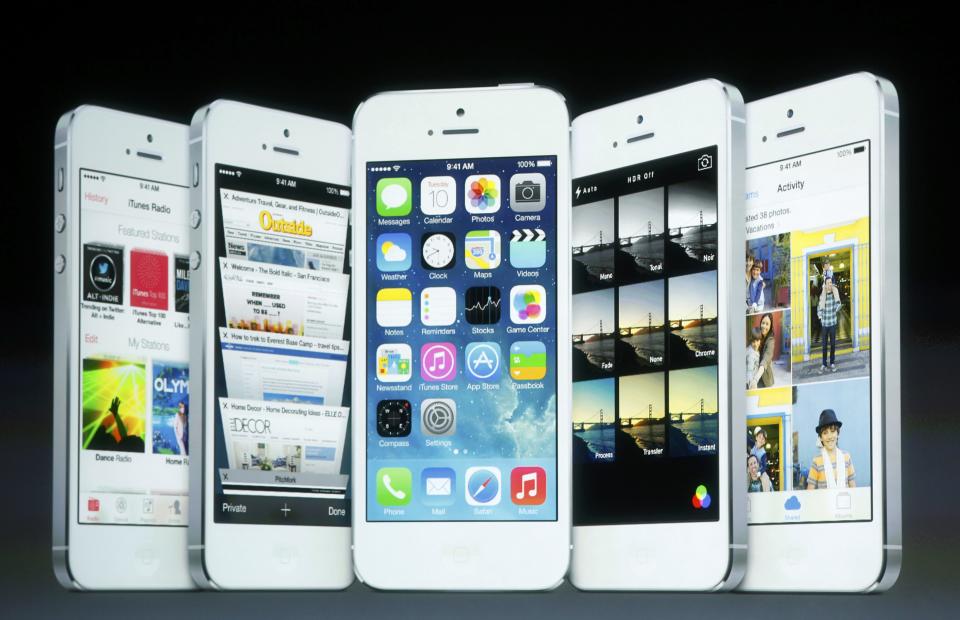 Screenshots of the iOS7 are seen on the screen during Apple Inc's media event in Cupertino