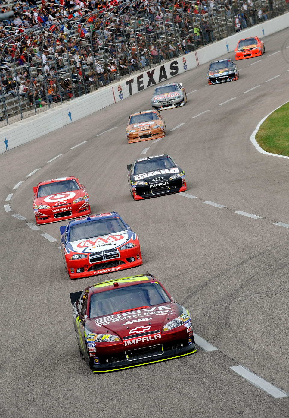 FORT WORTH, TX - NOVEMBER 06: Jeff Gordon, driver of the #24 Drive to End Hunger Chevrolet, leads a pack of cars during the NASCAR Sprint Cup Series AAA Texas 500 at Texas Motor Speedway on November 6, 2011 in Fort Worth, Texas. (Photo by Jared C. Tilton/Getty Images for NASCAR)