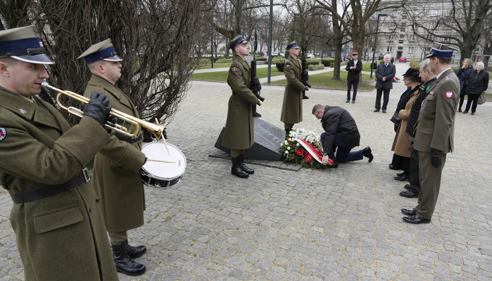 Members of a foundation supporting Poles who saved Jews from the Holocaust, honour Polish resistance unit that was tasked with aiding and saving Jews, during national day of remembrance of Poles who risked their lives to save Jews, in Warsaw, Poland, on Friday, March 24, 2023. The solemn meetings, wreath laying and prayers Friday were held 79 years after the entire Ulma family were shot dead along with eight Jews whom their were hiding in their farm. (AP Photo/Czarek Sokolowski)