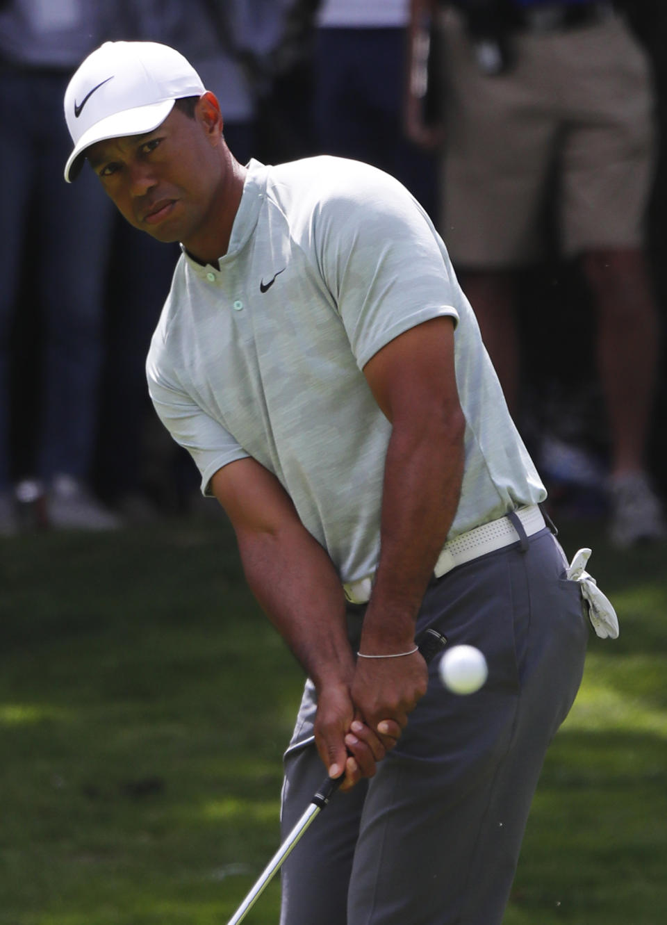 Tiger Woods chips the ball into the 1st hole green, on the third round of competition of the WGC-Mexico Championship at the Chapultepec Golf Club in Mexico City, Saturday, Feb. 23, 2019. (AP Photo/Marco Ugarte)