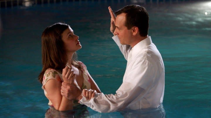 A woman gets baptized in a pool in Big Love.