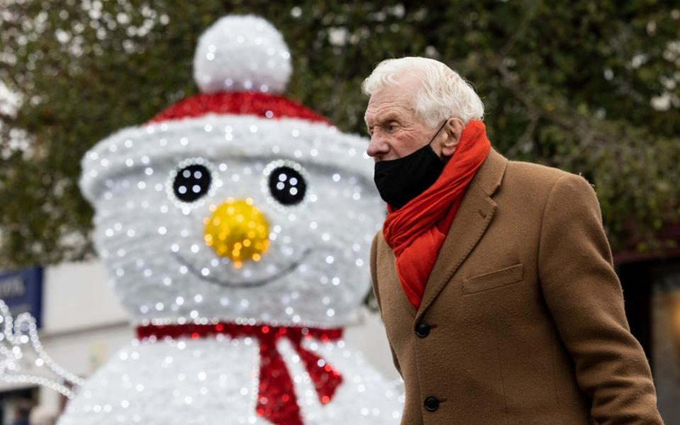 A member of the public walks past a snowman Christmas decoration on November 27, 2020 in Royal Tunbridge Wells - Dan Kitwood / Getty