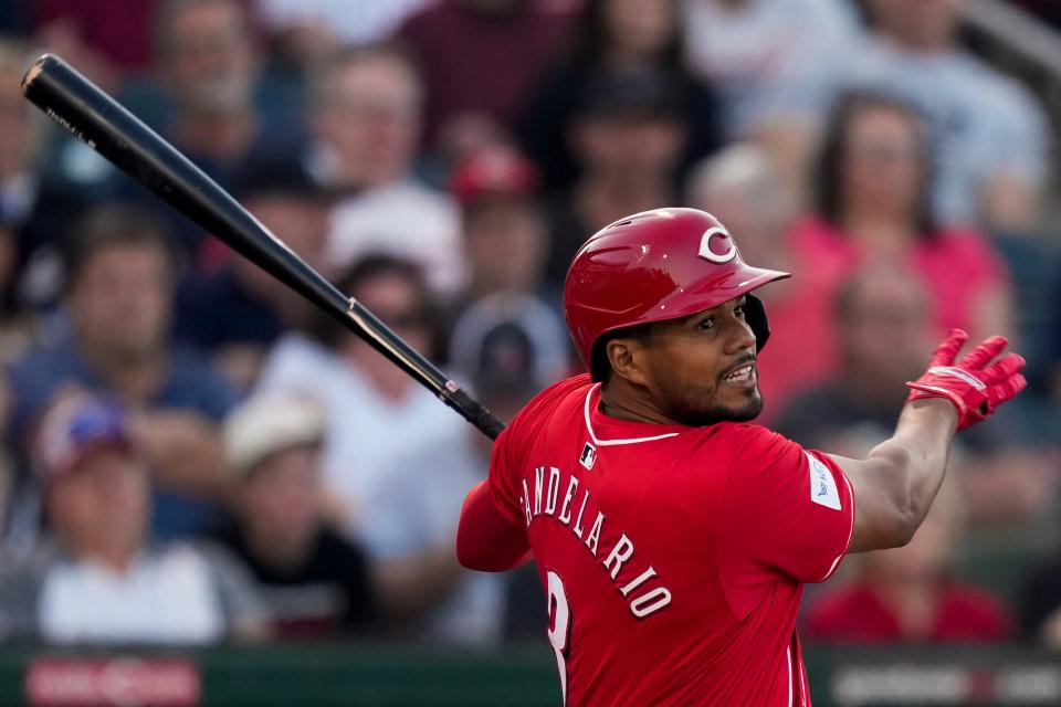 Jeimer Candelario hits a single in the first inning of Thursday night's game against the Los Angeles Dodgers. Five teams were interested in Candelario in free agency, including the New York Yankees, before he signed with the Reds.