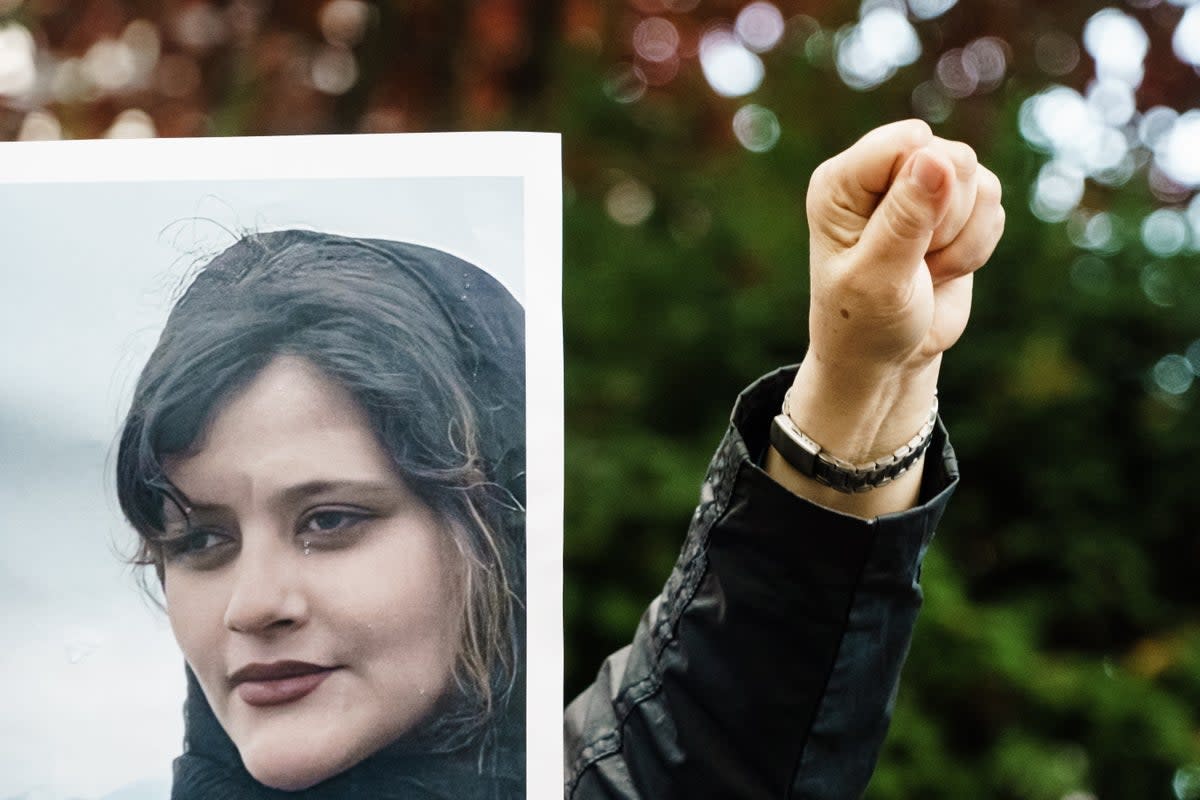 A protester of the National Council of Resistance of Iran gestures during a demonstration over the death of Mahsa Amini (EPA)